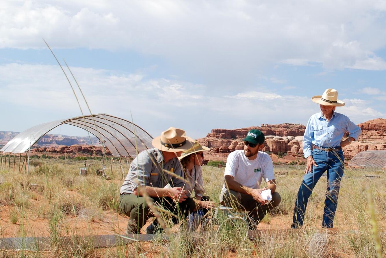 USGS Scientist discusses seasonal drought experiment results with local rancher and the National Park Service staff.
