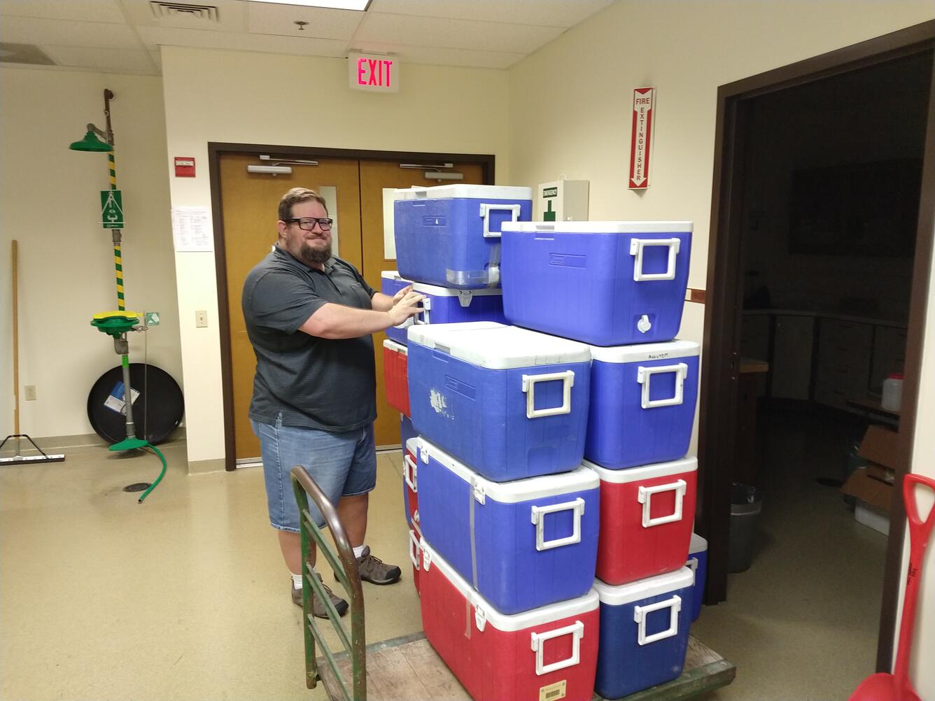 person, cart, coolers, lab, blue, red, doors