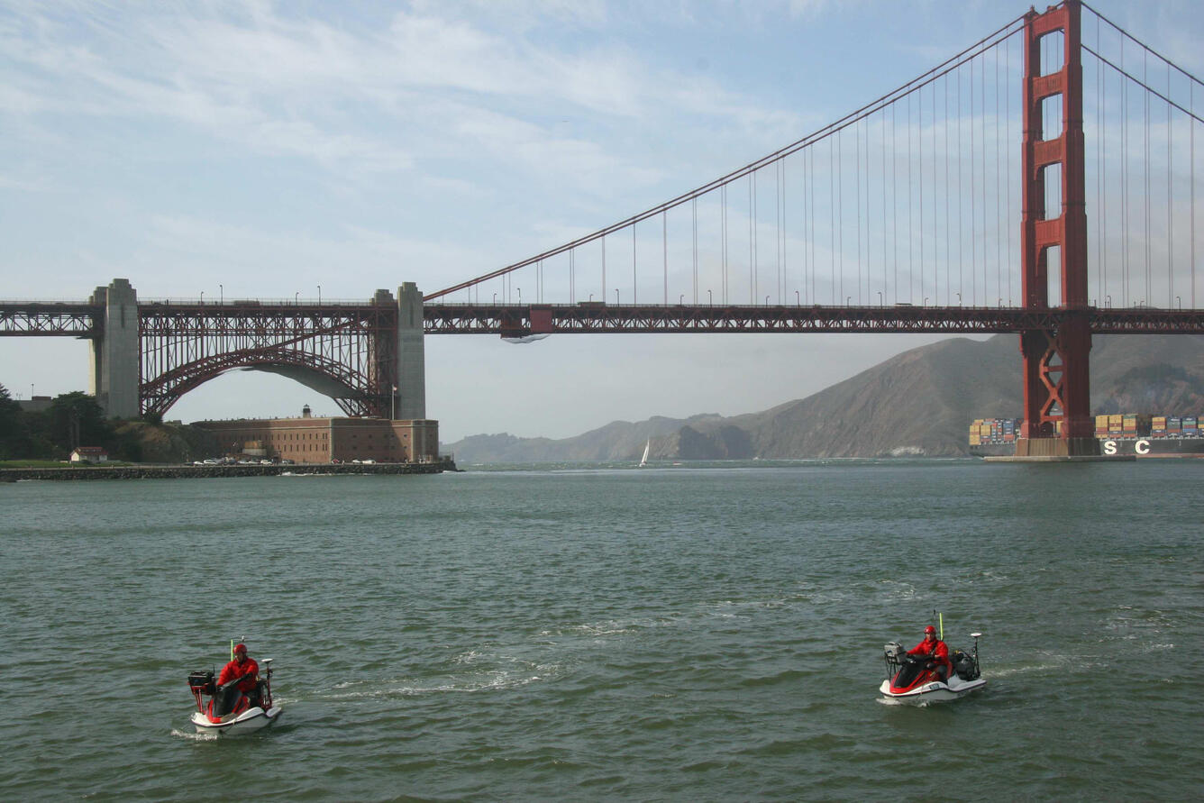 Jeff Hansen on the right runs a bathymetric survey in the shallow regions of San Francisco Bay near the Golden Gate Bridge.
