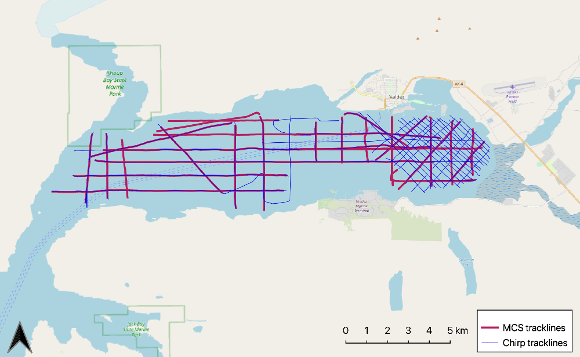 Map of a water inlet along a coastline, with lines drawn on the water to show the path of a ship survey.