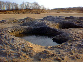 This is a photo of holes dug by collectors in search of amber in the Sayreville sand pits.