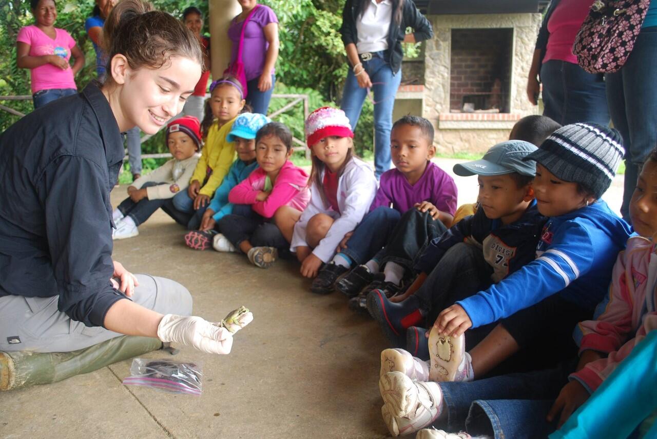 Grace showing a group of school kids a frog