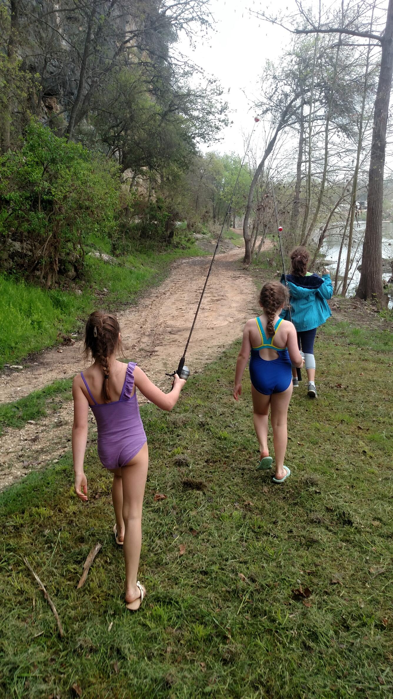Children explore and fish along the banks of the Guadalupe River near historic Gruene, Texas.