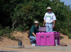 USGS scientists Fred Stumm (left) and Tony Chu (right) monitor data on laptop while testing seismometer in New York.