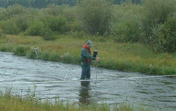 Kirk Miller (USGS) makes discharge measurements used for comparison with fiber-optic distributed temperature sensing results