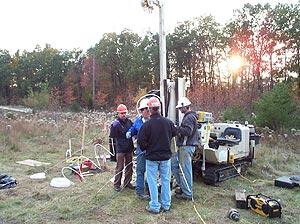 USGS scientists prepare to install a well at the study area
