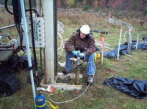 Jason Smith conducts slug tests during well installation at the study area