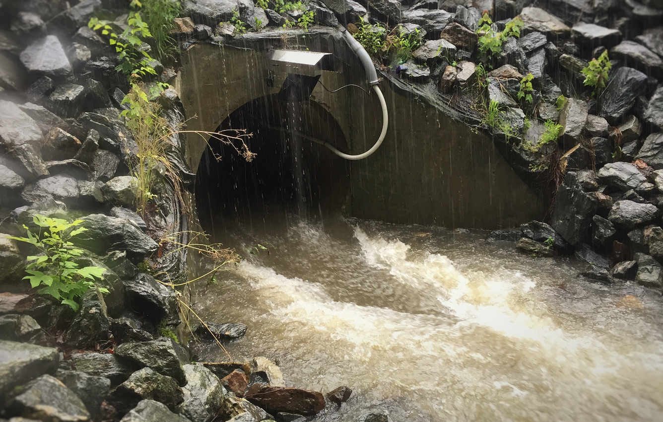 Water rushing through a culvert during a storm