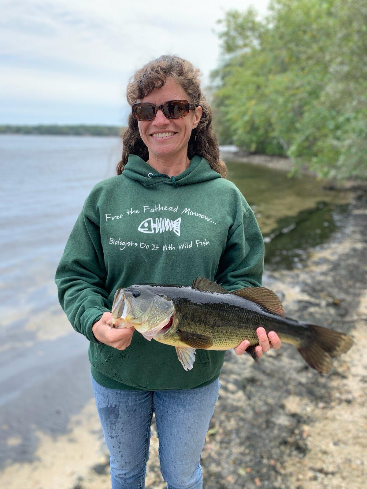 Heather Walsh holding a large mouth bass