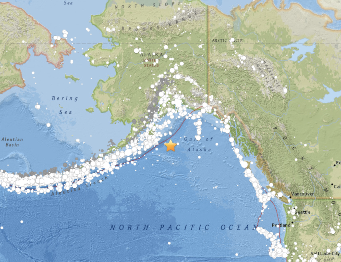 Map showing part of southern Alaska and Gulf of Alaska, with orange star in Gulf & white dots strung out along Aleutian Islands