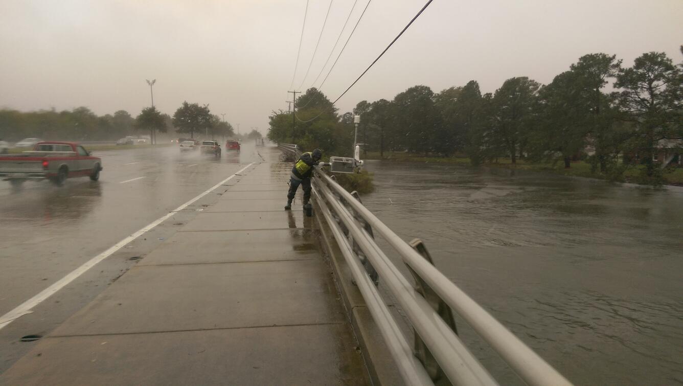 USGS scientist Carlos Rodriguez, deploying a sensor at Newmarket Creek at Mercury Boulevard in Hampton, VA. Credit: USGS