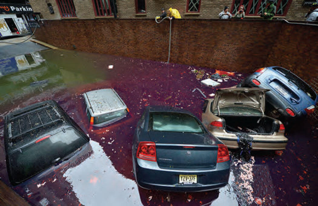 Photograph of cars and debris in a flooded low area in New York City after Hurricane Sandy. 