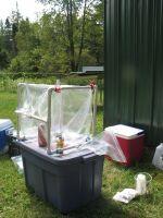 photo of groundwater sampling equipment and cooler on lawn