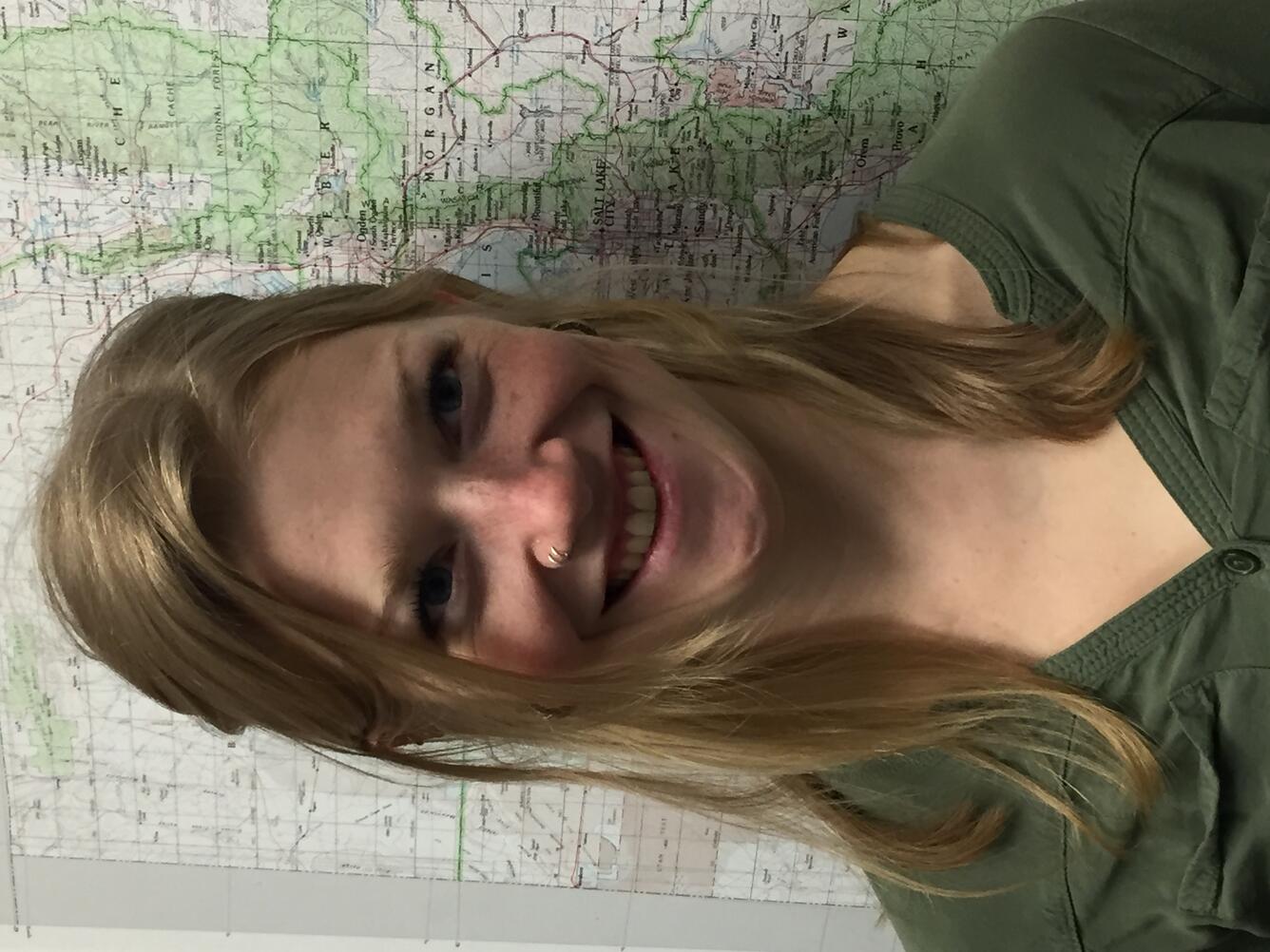 Photo of Scientist Kate Jones in front of a map of Utah