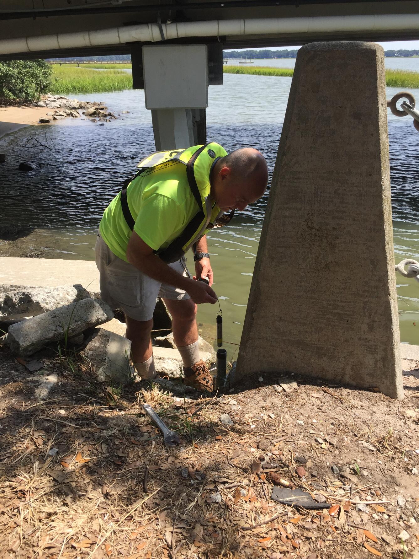 USGS hydrologic technician deploying a storm surge sensor