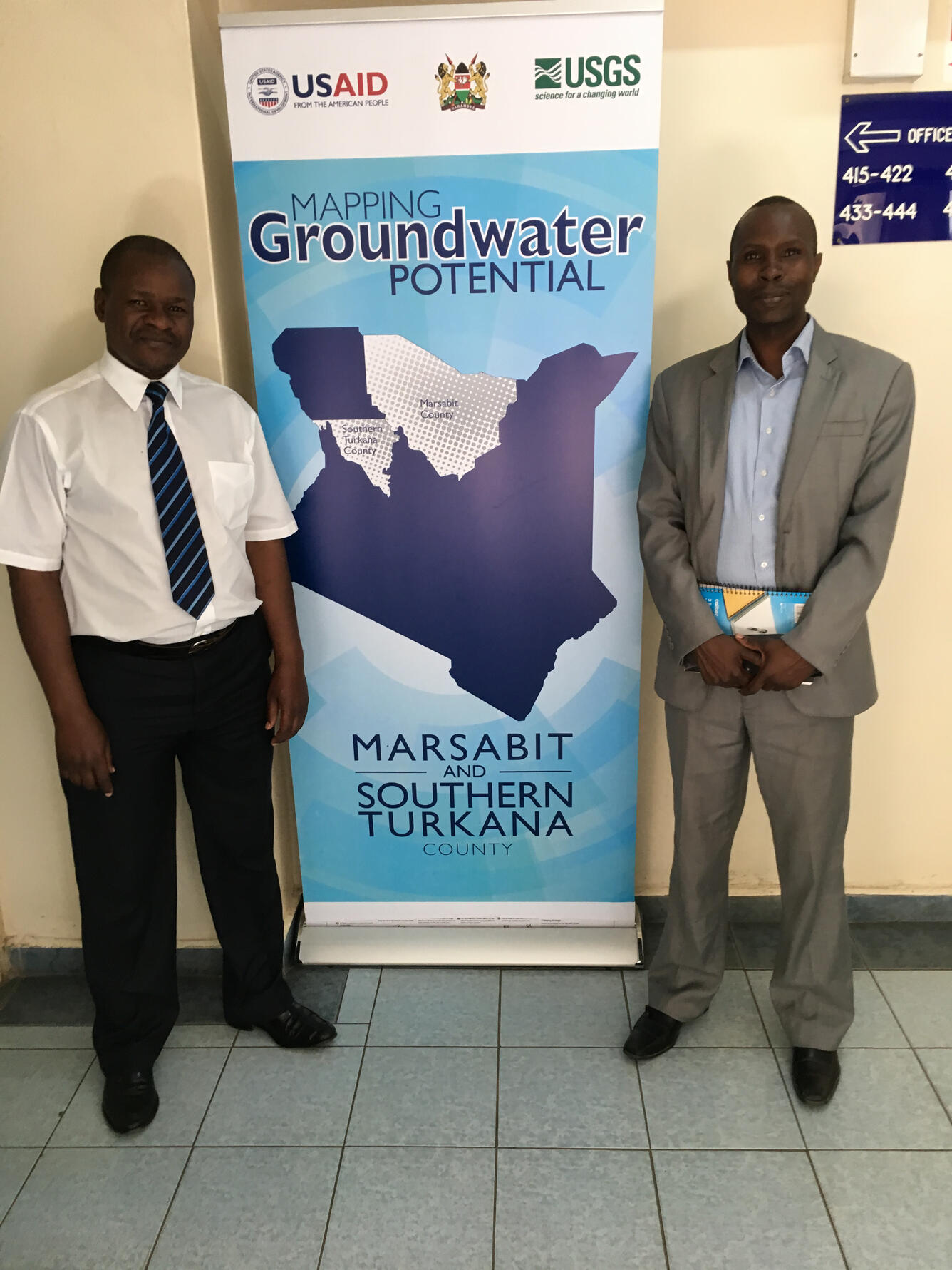 Image of Cooperators for the Africa Groundwater study standing next to a banner