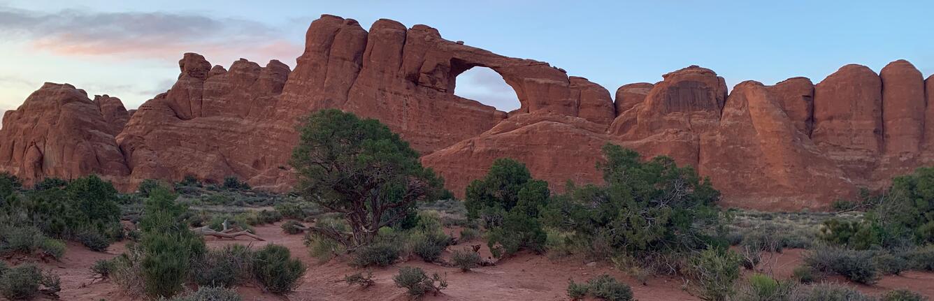 This image shows a large sandstone arch and surrounding rocks.