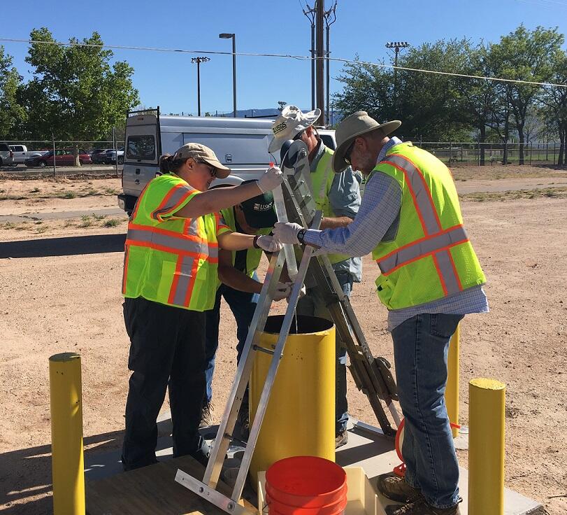 Technicians sampling a sentinel well in Albuquerque, New Mexico