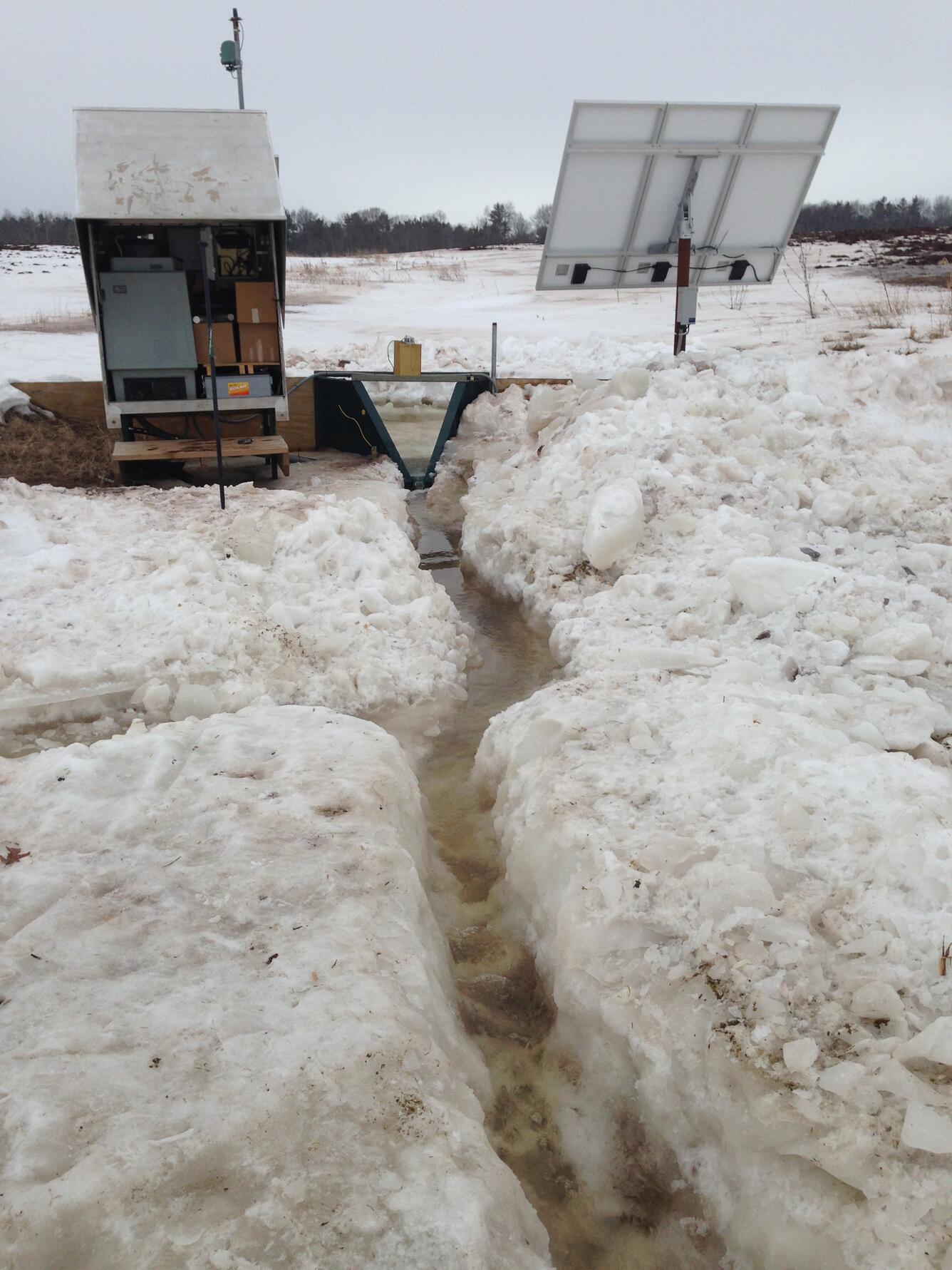 Photo of a winter runoff event at an edge-of-field surface site.