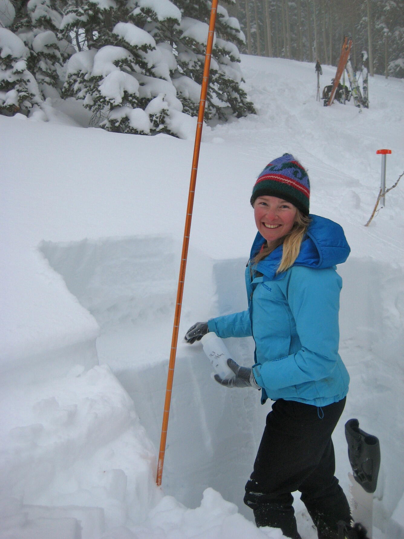 Photo of scientist, Olivia Miller, collecting snow samples