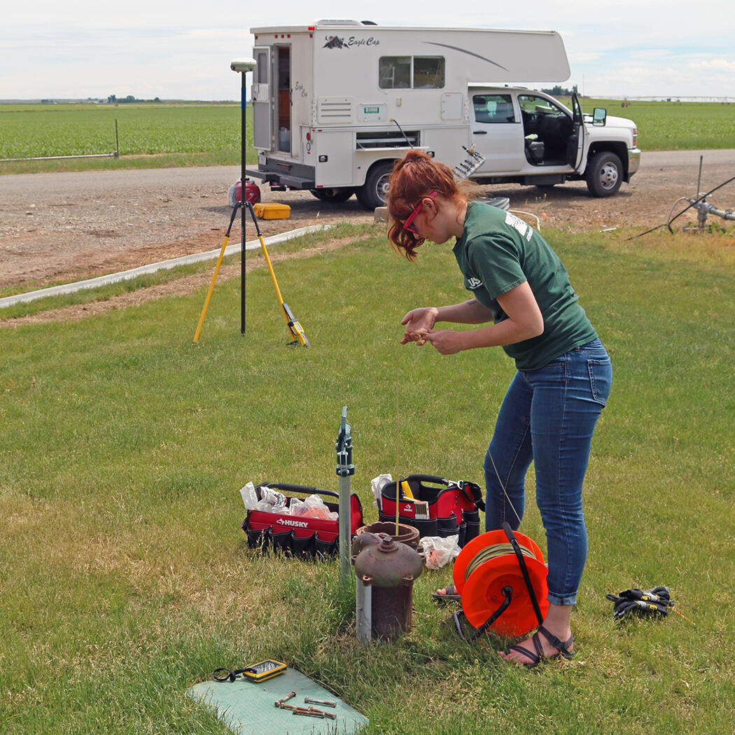 USGS hydrologist measuring the groundwater level in a well in southern Idaho