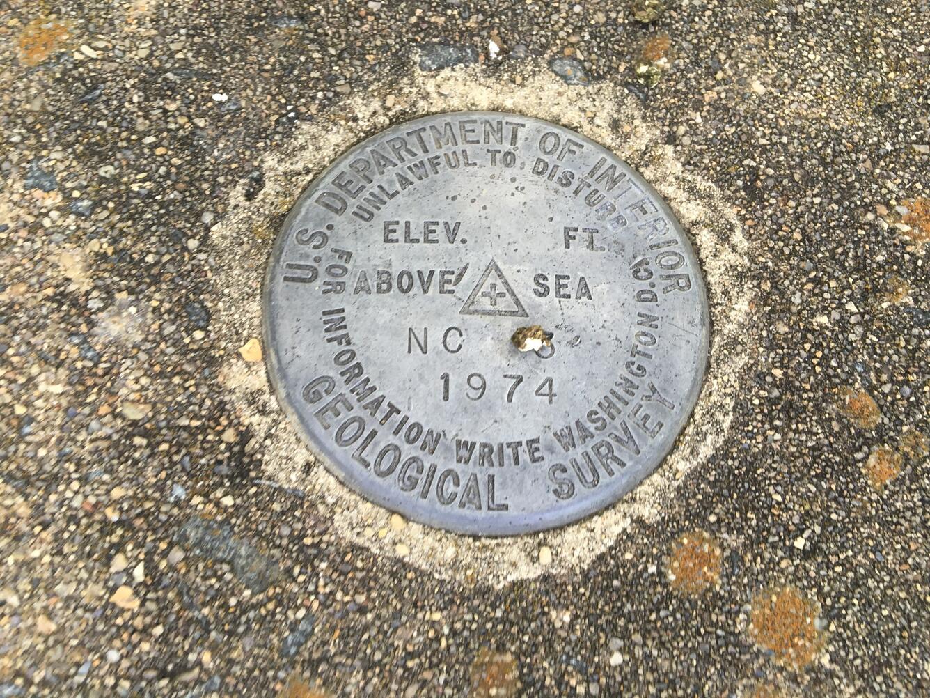 Image shows a benchmark set in concrete