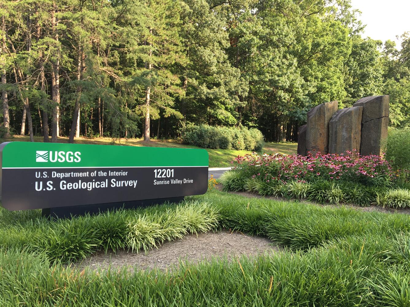 Image shows the USGS Welcome Sign and gray stone columns