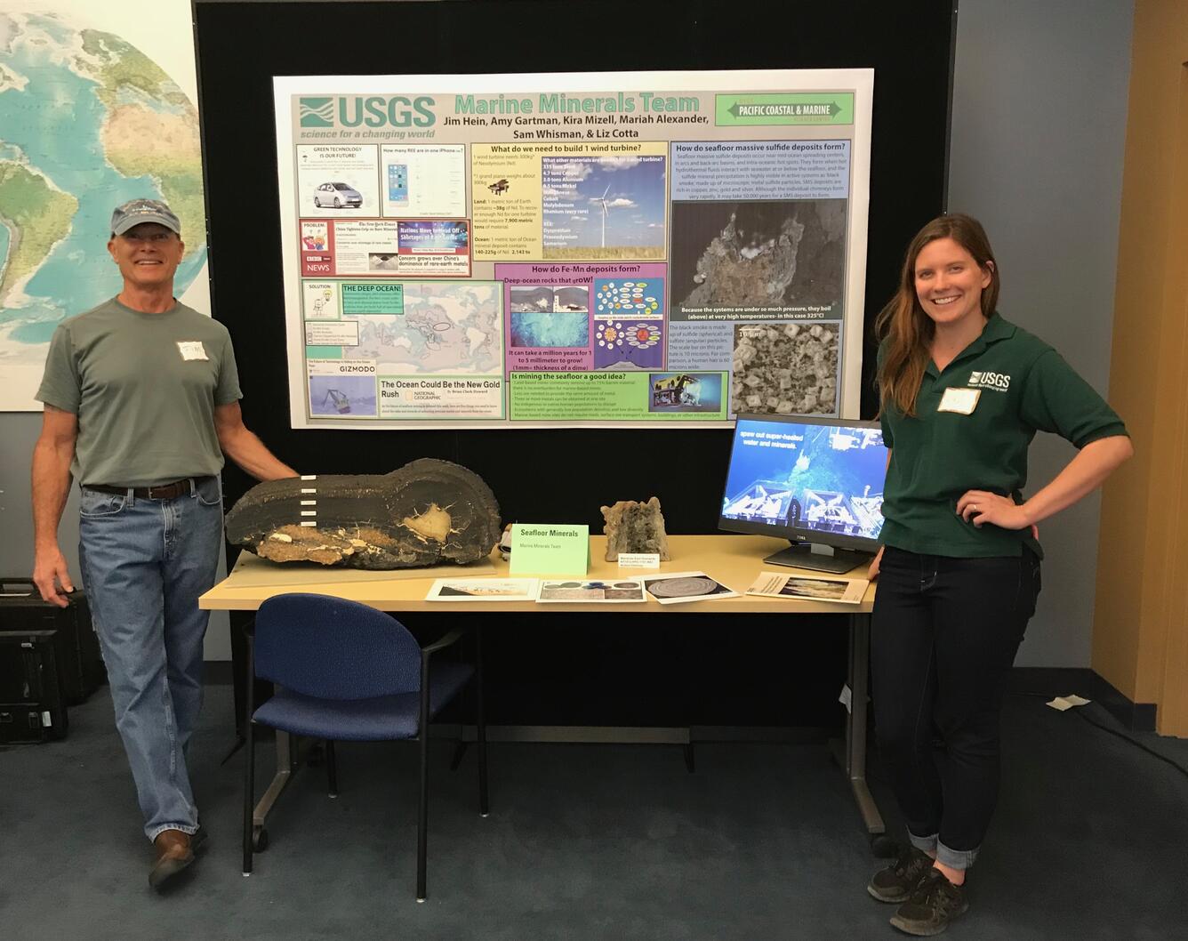 Geologist Jim Hein and Physical Science Technician Kira Mizell stand with their display of seafloor minerals for an event.