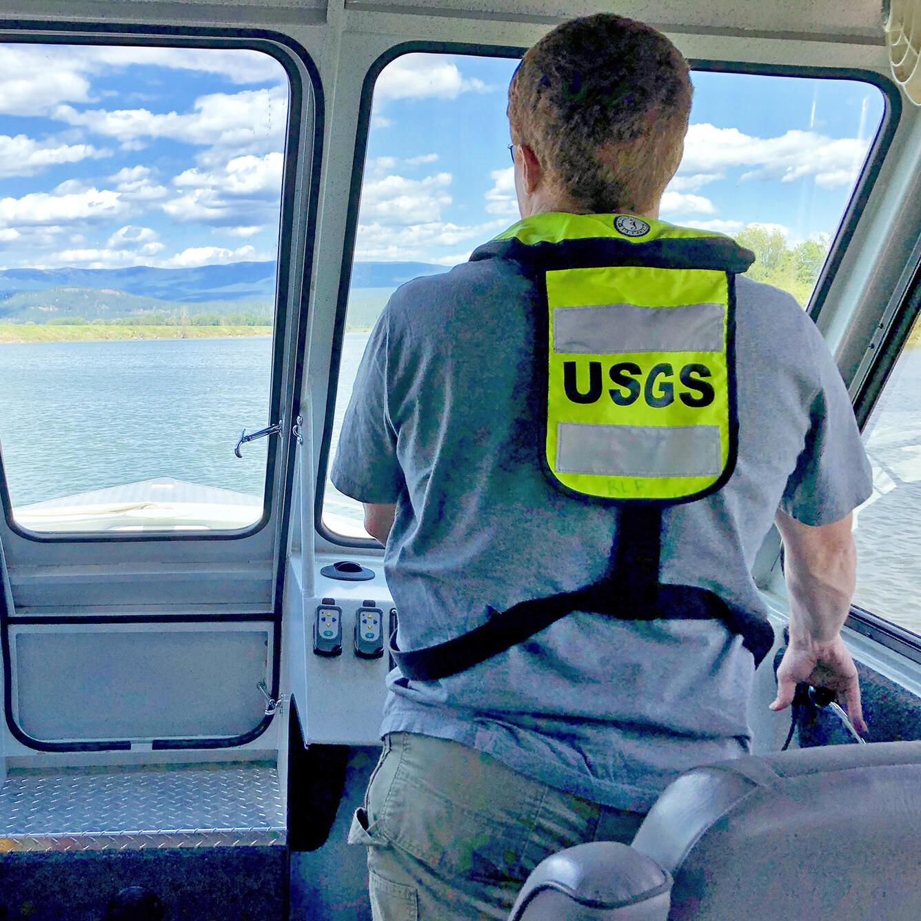 USGS hydrologist piloting research vessel on the Kootenai River, Idaho