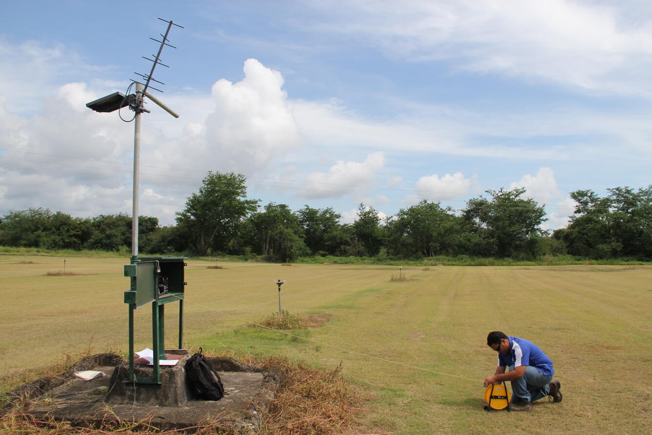 Technician taking measurement ground water site.