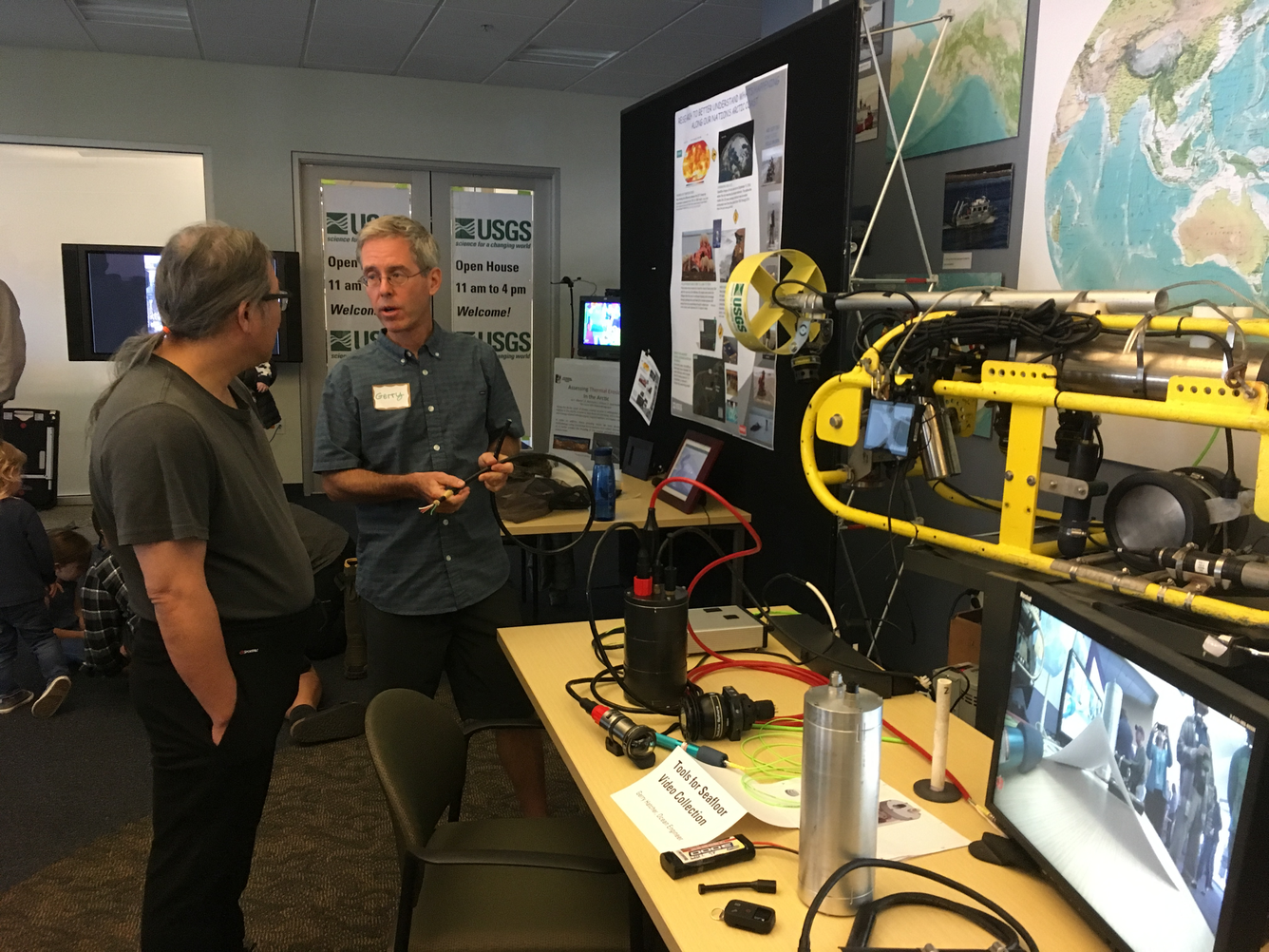 USGS Ocean Engineer Gerry Hatcher explains his equipment for collecting underwater video to a visitor.