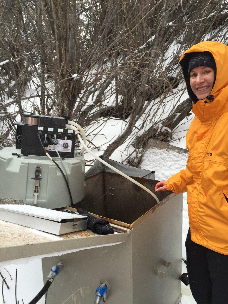 Scientist services an automatic sampler, in the snow, that has been installed at the gaging station on Clear Creek in Nevada.