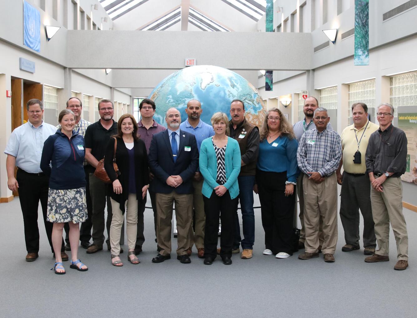 Color photo of International Charter for Space and Major Disasters project managers at USGS EROS Center