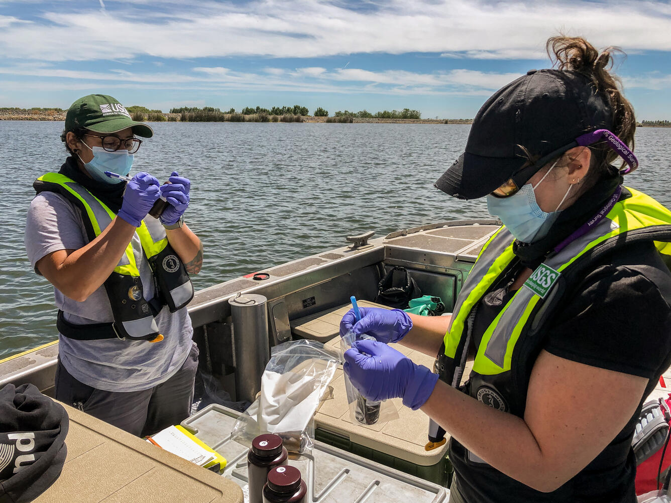 Jeniffer Soto Perez (left) and Emily Richardson (Right) prepare water quality sample bottles onboard the RV Landsteiner