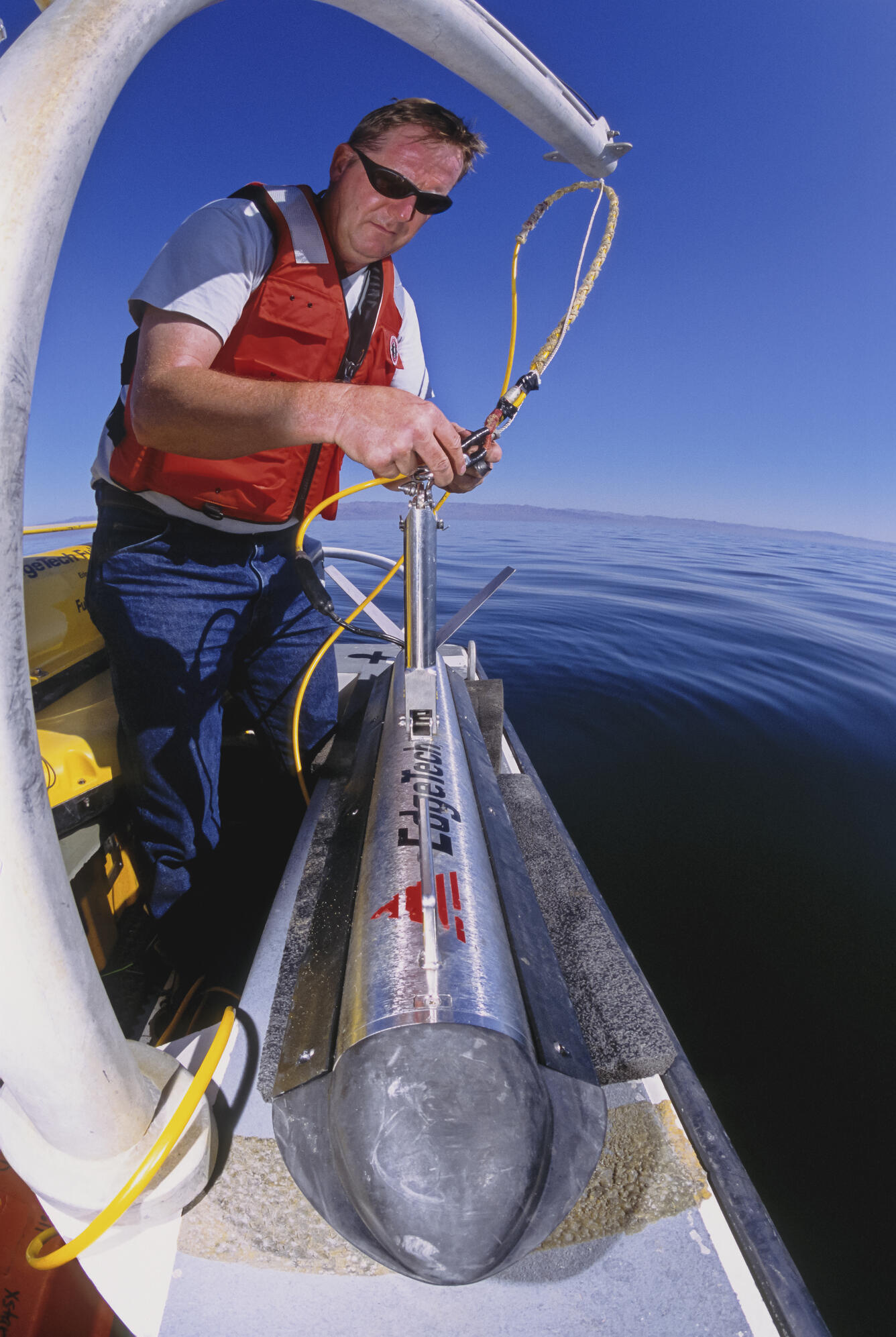 Photo of USGS scientist Robert Baskin deploying a side scan sonar in the Salton Sea, California.