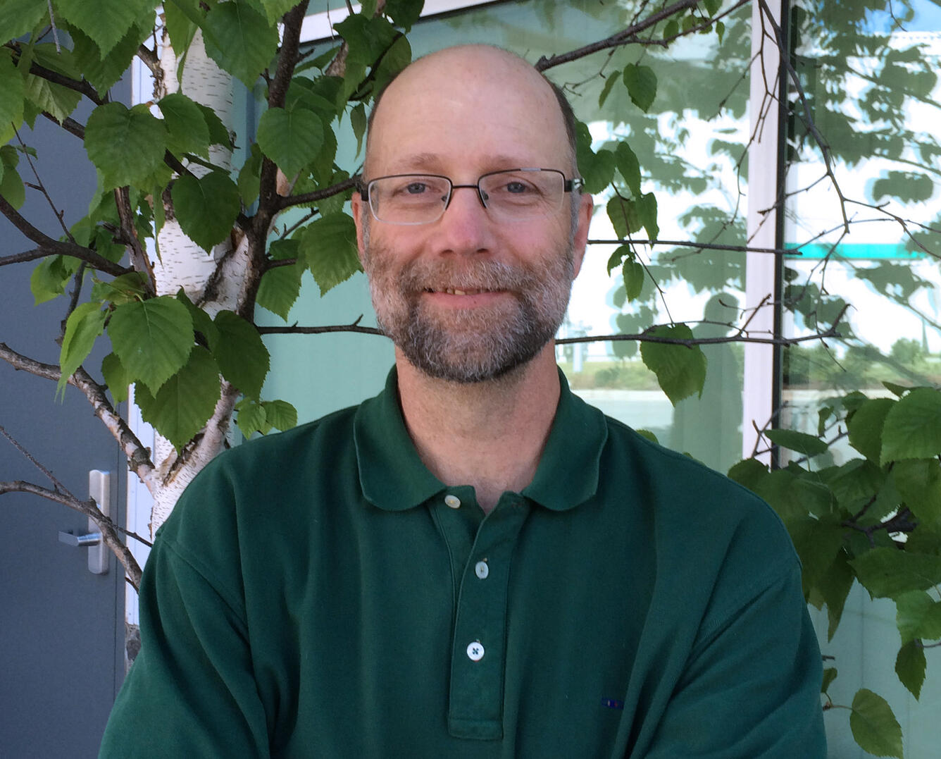 Joel Schmutz standing in front of the USGS, Alaska Science Center Anchorage office