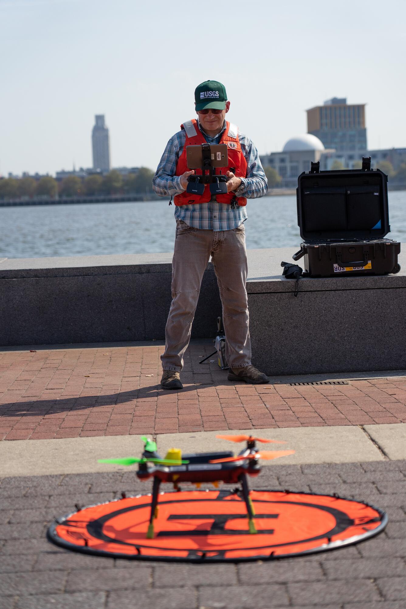 USGS employee prepares unmanned aerial vehicle for takeoff