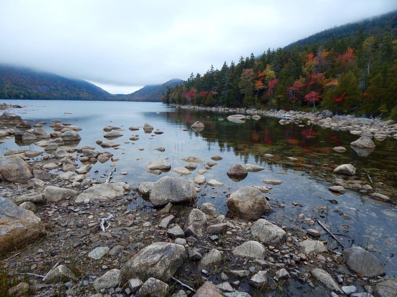 Lake with mountains and fall foliage surrounding it