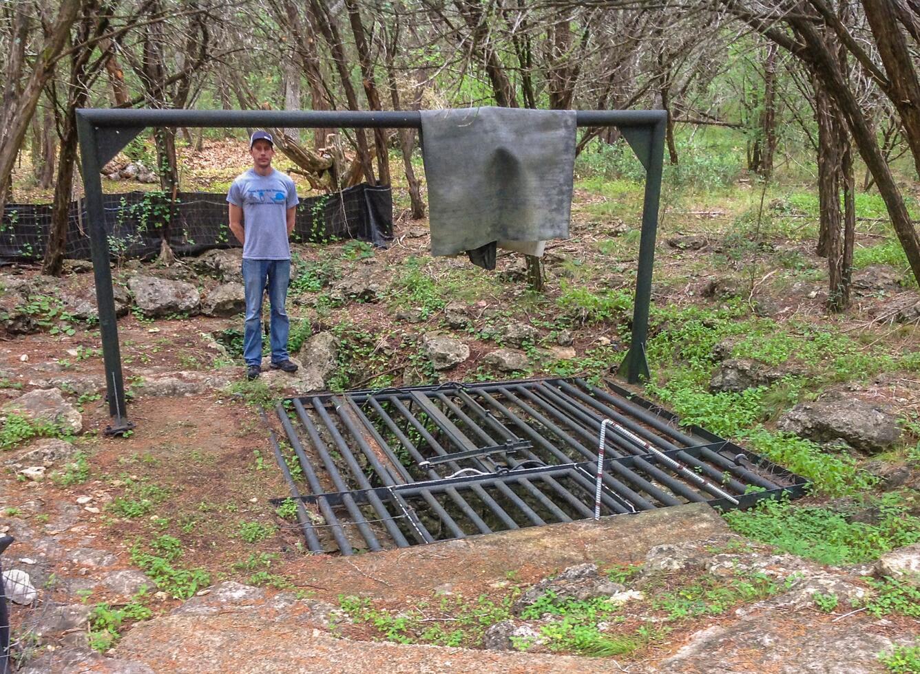 Locked metal gate covering the group opening to Friesenhahn Cave