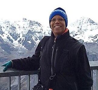 Photo of Kimberli J Miller in front of mountains.