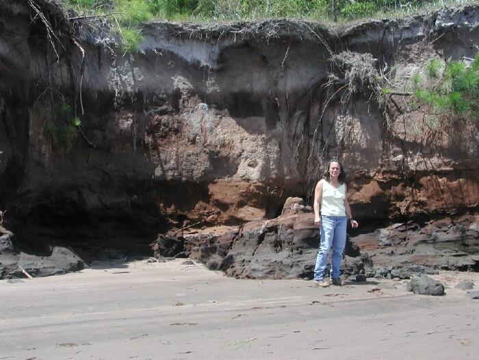 USGS scientist examining an outcrop of organic-rich sediment that drives sustainable natural attenuation