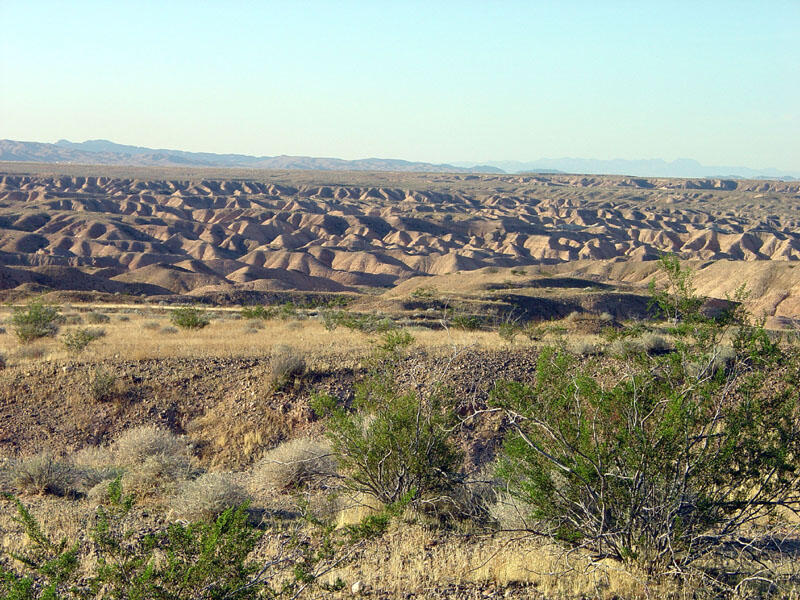 This is a photo of a view west over badlands of an eroding pediment near the intersection of the Overton Beach.