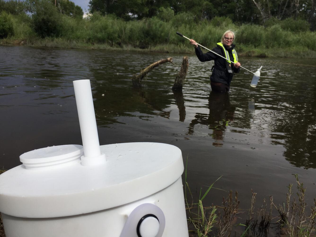 Filling teflon churn with water sampled from Laramie River nr Laramie