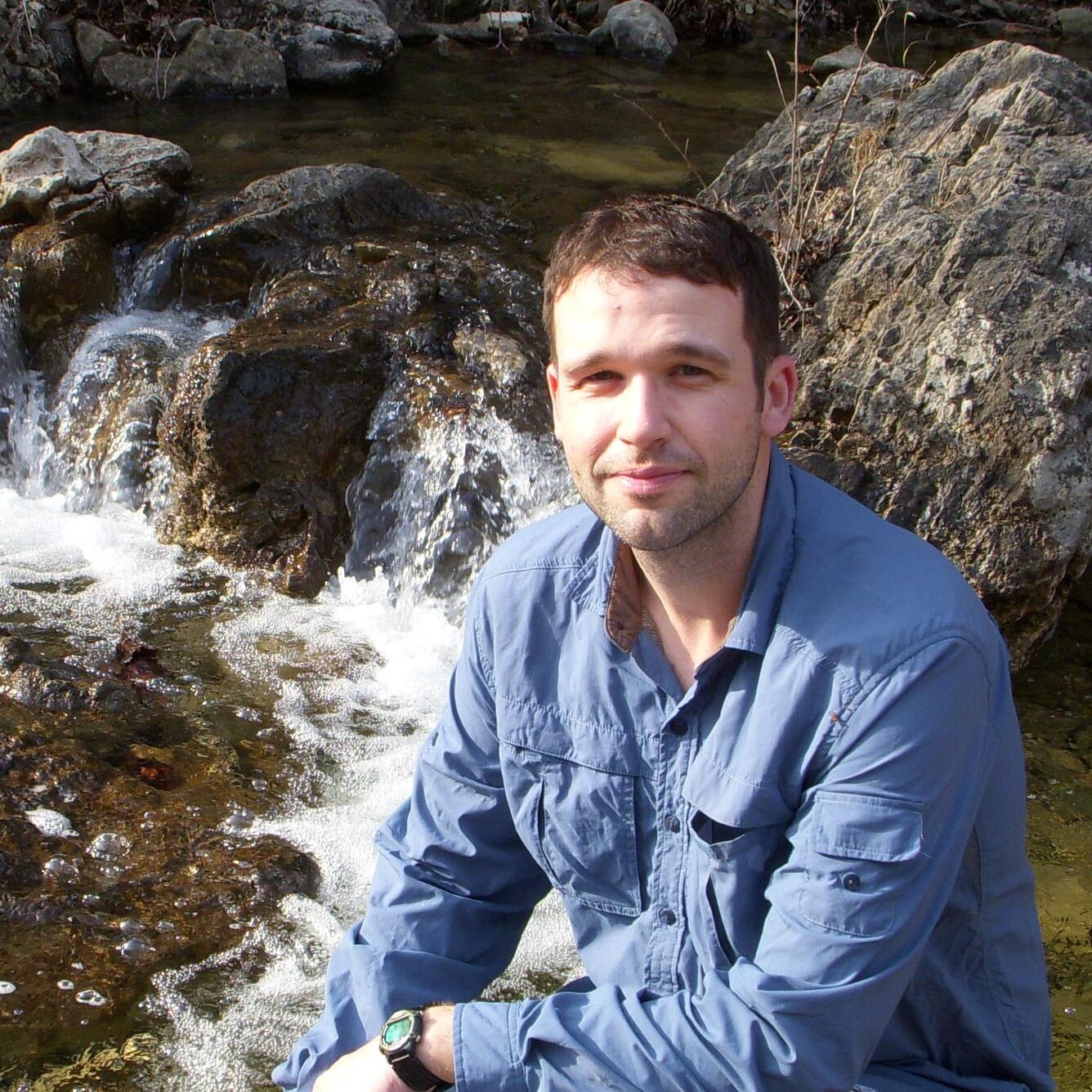 Jeffrey Lorch in front of water and rocks.