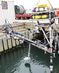 Bottom lander with moving arm to profile near sea bed parameters.