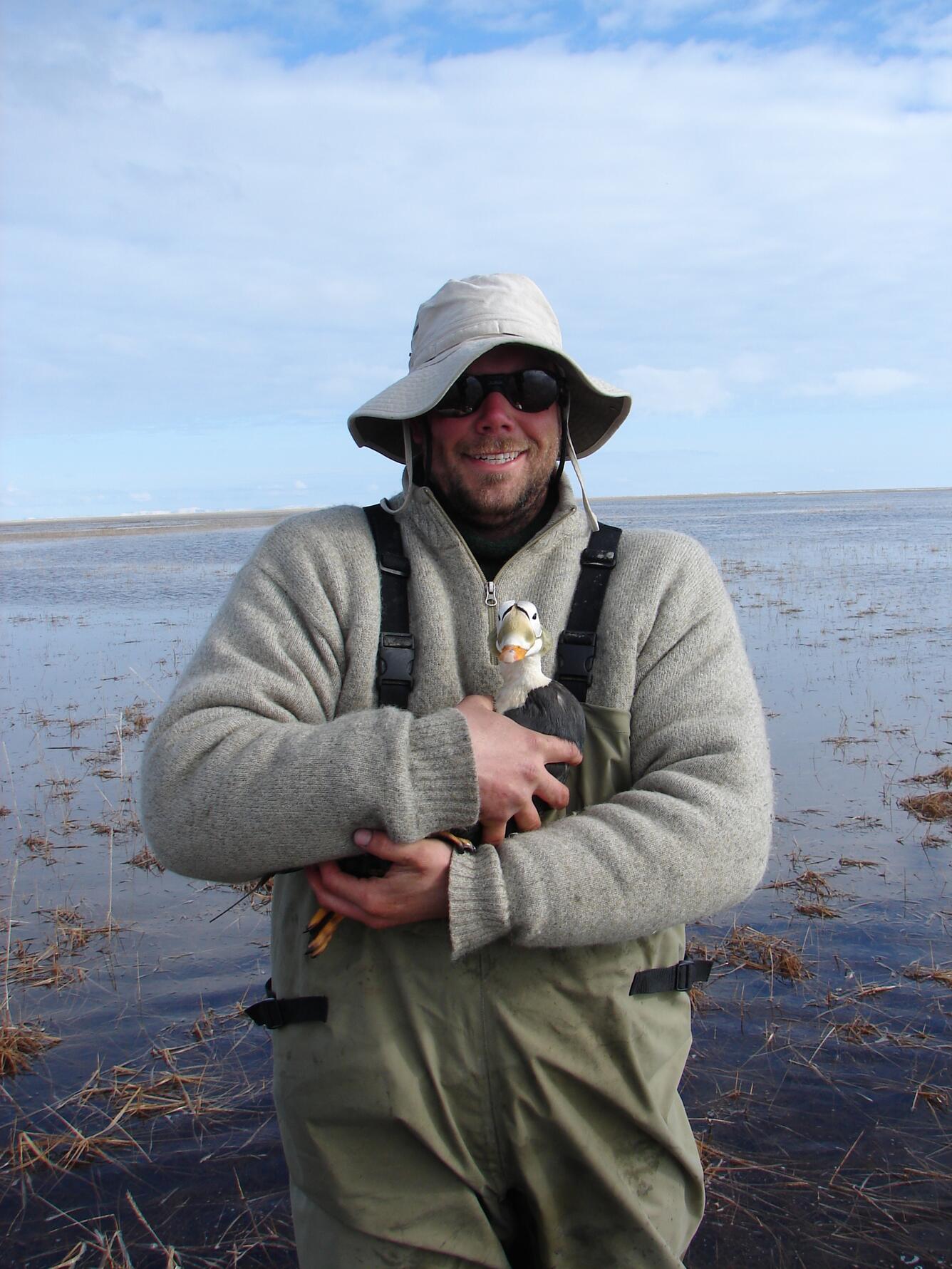 Matt Sexson holding a Spectacled Eider