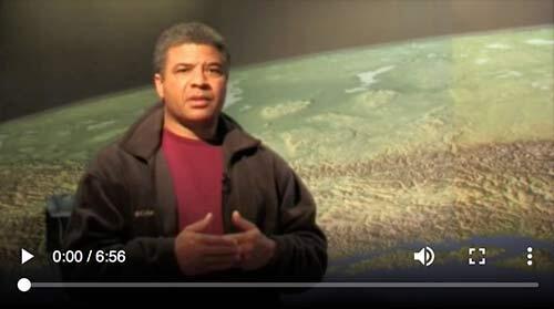 man in front of slideshow presentation