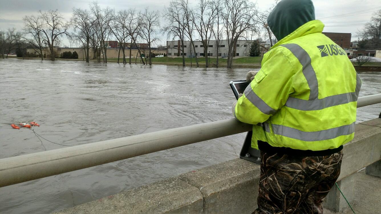 A USGS hydrologic technician takes a discharge measurement of the St. Joseph River in Michigan. 