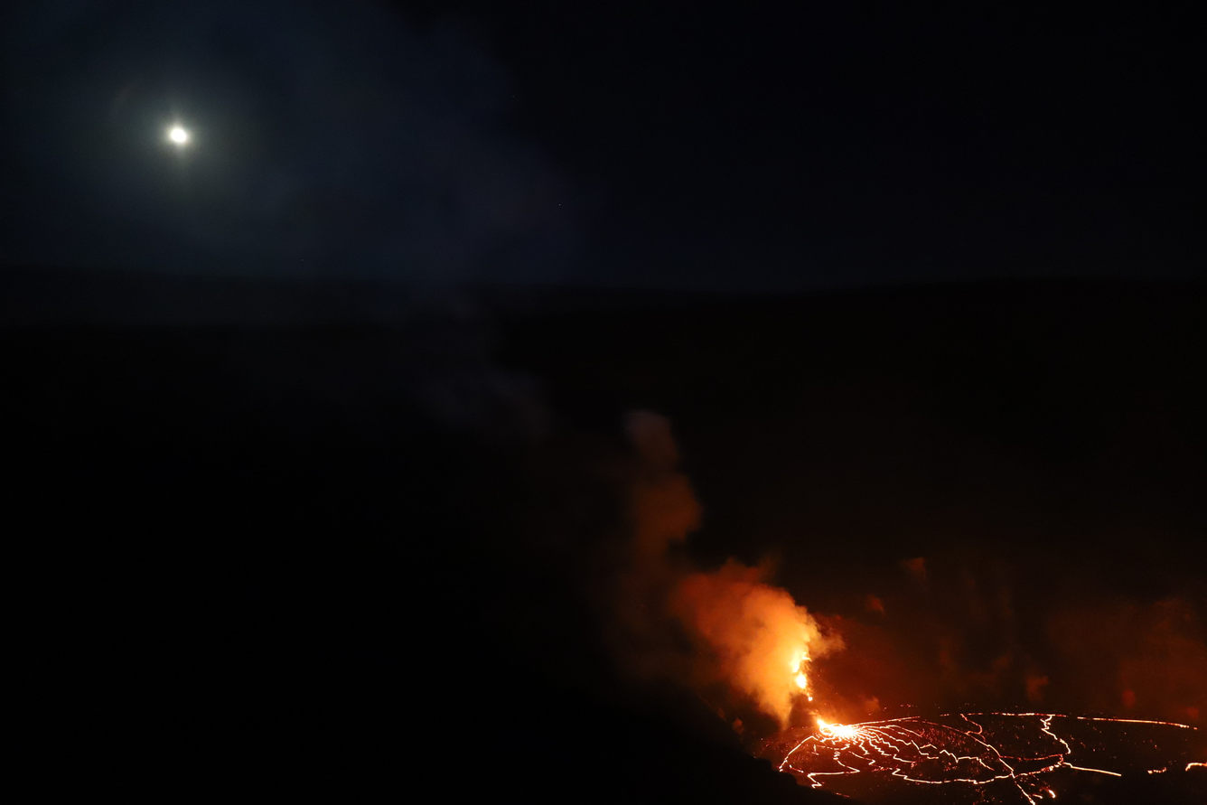 Color photograph of lava lake and moon