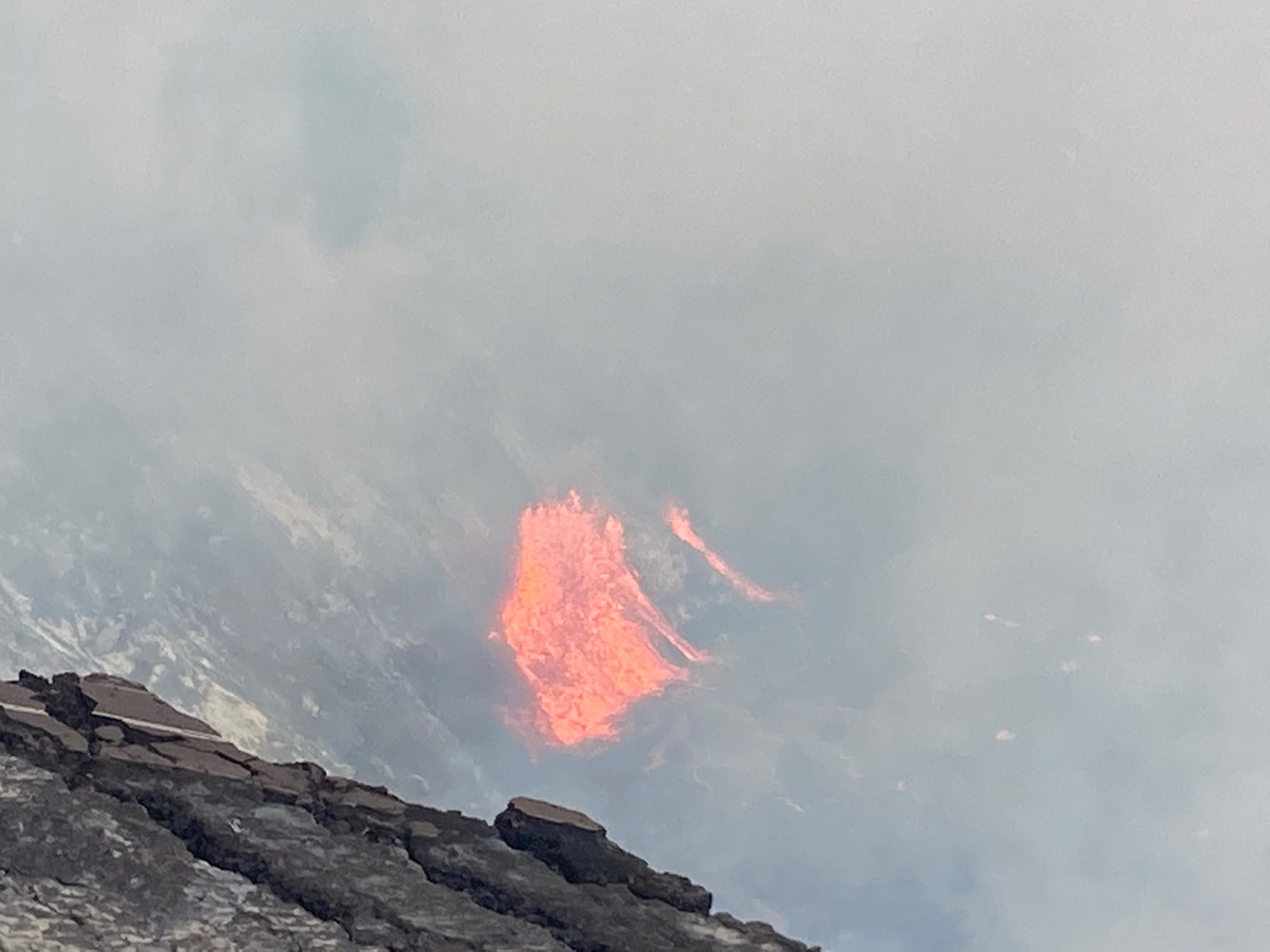 Color photograph of volcanic vent erupting